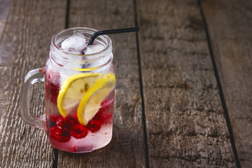 Infused Water with Lemon and Raspberry Healthy Detox Drink Cold Berry Fruit Lemonad in Glass Jars Wooden Background Vertical