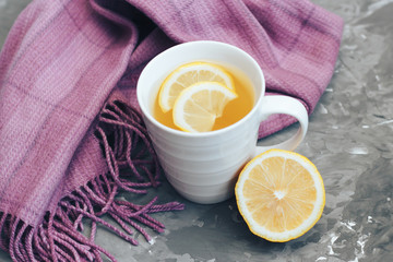 Lemon tea and a scarf on a gray background