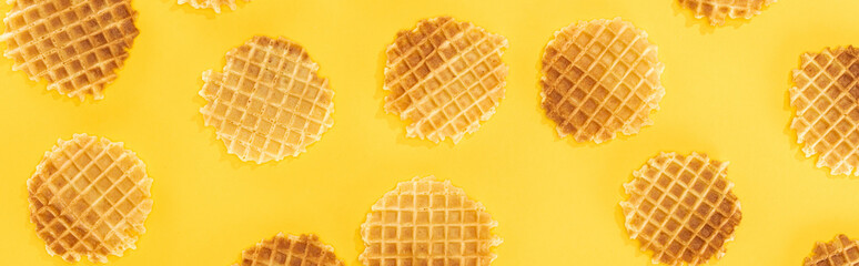 panoramic shot of crispy waffles isolated on yellow
