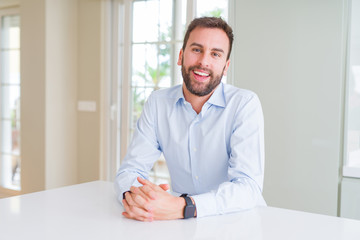 Fototapeta premium Handsome business man smiling positive at the camera