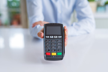 Close up of man hands holding pos terminal