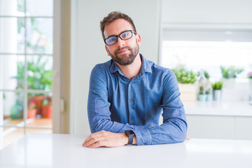 Fototapeta premium Handsome man wearing glasses and smiling relaxed at camera