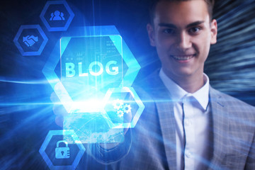 The concept of business, technology, the Internet and the network. A young entrepreneur working on a virtual screen of the future and sees the inscription: Blog
