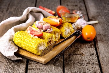 Grilled Corn Cobs and Tomatoes with Garlic and Spices on Wooden Tray Wooden Background Vegetarian Dish Healthy Diet Food Horizontal