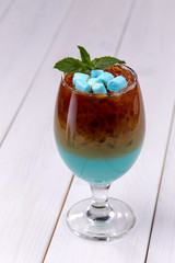 blue cocktail with marshmallow and mint