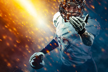 American football sportsman player on stadium running in action. Sport wallpaper with copyspace. - Powered by Adobe