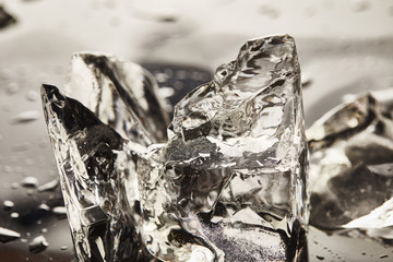 close up view of pure melting ice cubes with drops
