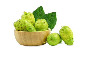 Noni or Morinda Citrifolia and pieces in a wooden cup, separate on a white background.