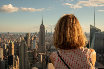 Blonde tourist taking a picture of the Empire State