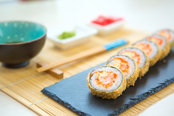 fried rice cover sushi rolls on black table, sea food Healthy and tasty food.