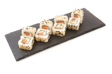 Fried Rolls with cheese and fried fish on black slate or stone shale surface on white background
