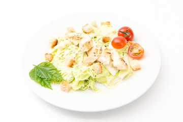 Homemade Vegetable salad with chicken and cheese on white rectangular plate on white background Healthy and tasty food.