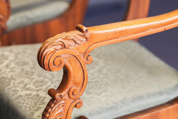 Fototapeta na wymiar Carved handle of vintage wooden chair