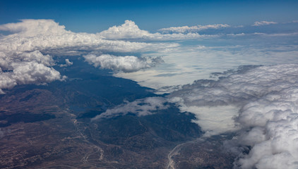 Fototapeta premium Cloudscape background. View out of a plane window.
