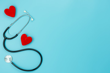Table top view aerial image of accessories healthcare & medical with Valentines day background concept.telescope with colorful heart shape on blue paper.Flat lay items for doctor using treat patient.