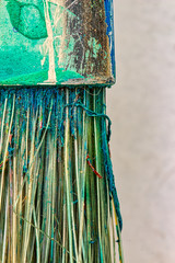 macro photograph of a used brush - detail of the ferrule and bristles of a used brush with remnants of dry paint