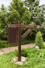Empty sign pointers with a space for text. Wooden pointers on a wooden pole