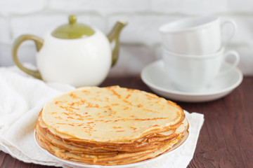 delicious fresh homemade pancakes and utensils for tea on the table