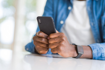 Close up of african man hands using smarpthone
