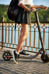 Teen high school girl with electric scooter near the water © frimufilms