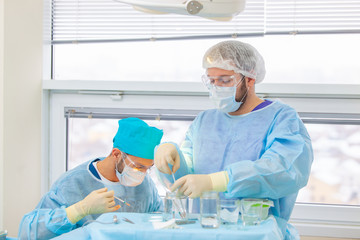 Baldness treatment. Hair transplant. Surgeons in the operating room carry out hair transplant...