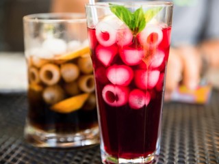 Two cold drinks with balls of ice.