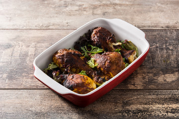 Roasted tandoori chicken with basmati rice on wooden table
