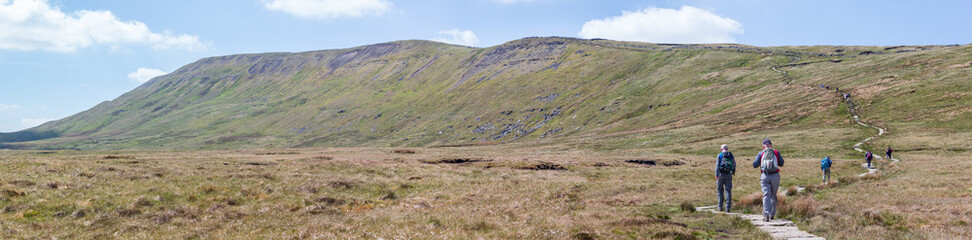 Fototapeta na wymiar Panorama of Walkers ascending Whernside in the Yorkshire Dales, England, UK