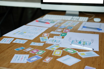 Naklejka premium user experience UX designer designing web on smart phone layout. UI developer planning working on mobile application prototype