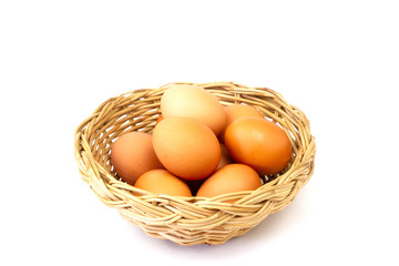 Fresh brown eggs in basket isolated on white background.