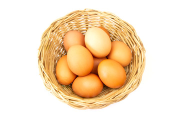 Fresh brown eggs in basket isolated on white background.