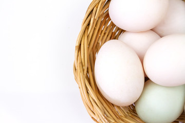 Fresh white eggs in basket isolated on white background.