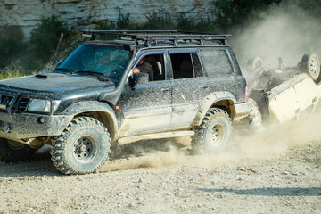 Offroad racing. The jeep carries a broken car