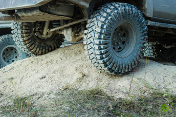 Off-road dirty car wheels. Swamp rubber. Jeep in the swamp. Trial competition.