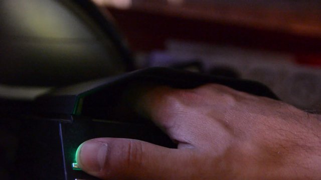 hand put in identity to id scaner. very low light. 