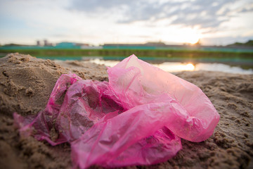 Cellophane package on the river bank. Environmental pollution.Garbage on the beach