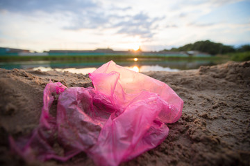 Fototapeta na wymiar Cellophane package on the river bank. Environmental pollution.Garbage on the beach
