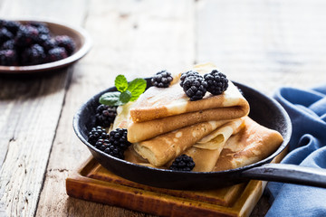 Morning meal, homemade crepes, fresh summer blackberries