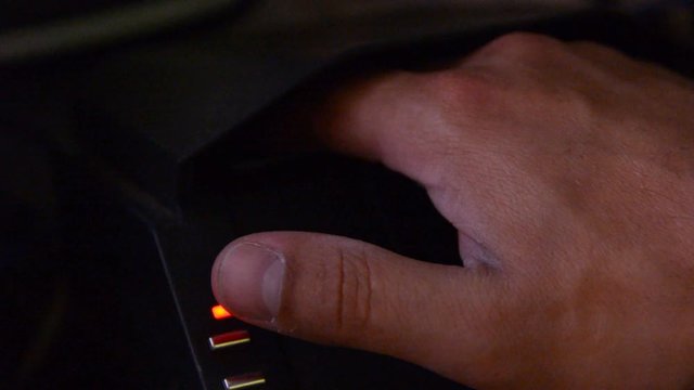 hand put in identity to id scaner. very low light. 