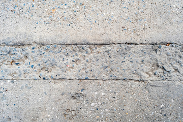 Obraz na płótnie Canvas Concrete sidewalk with years of cracks, wear and tear 