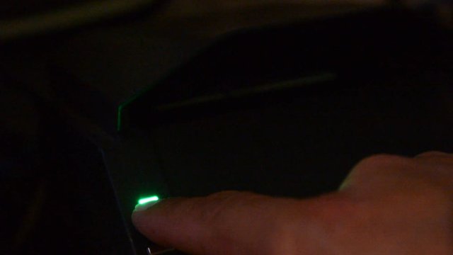 hand put in identity to id scaner. very low light. 