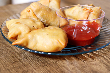 Veg Samosa - is a crispy and spicy Indian triangle shape snack which has crisp outer layer of maida & filling of mashed potato, peas and spices.