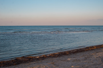 Beautiful seascape - sunset on the sea and bright pink-blue sky and blue calm sea cover.