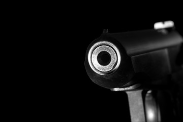 Gun barrel close up on black background.Shooting weapon