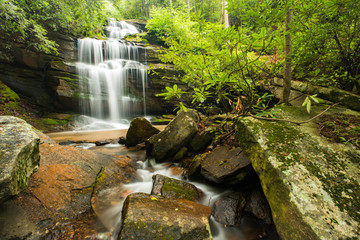 Gorgeous springtime waterfall in the mountains of North Carolina showing the green foliage.