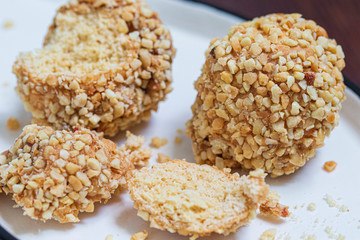 Round cake sprinkled with nuts. Shortcrust pastry dessert.