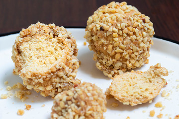 Round cake sprinkled with nuts. Shortcrust pastry dessert.