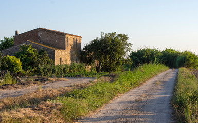 cottage in the countryside at sunset . image