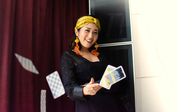 A gypsy woman is throwing tarot cards