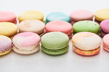 Fototapeta na wymiar sweet colorful French macaroons of different flavors on white background